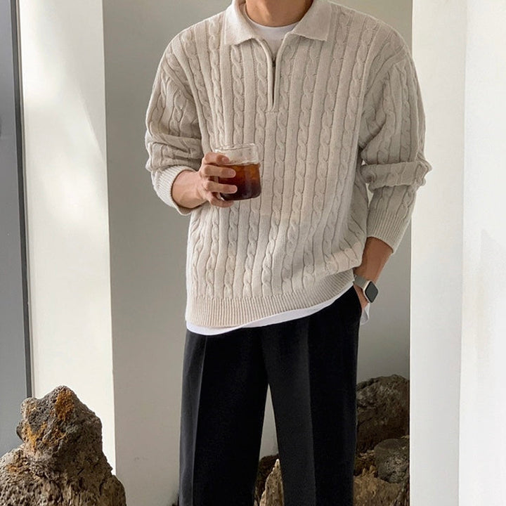Men's cable knit quarter zip polo jumper in cream – Wrenley – front view holding a drink