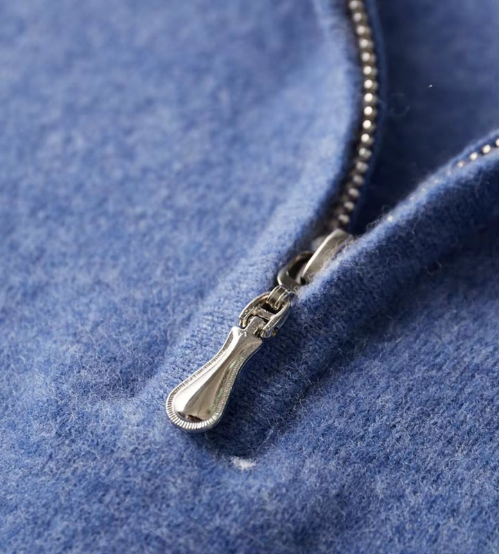Blue knitted polo jumper – close-up of metal zip pull