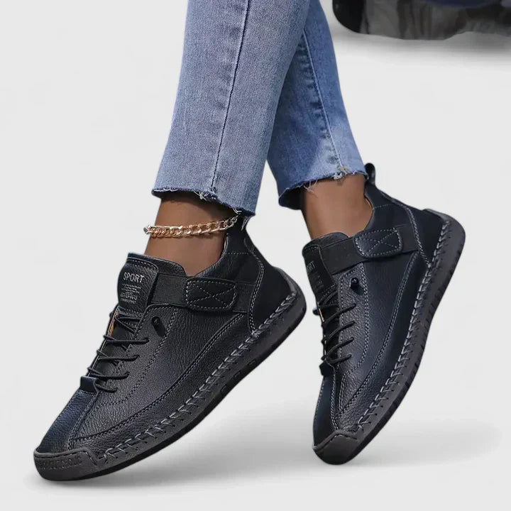 Women's lace up trainers Yvie in Black – on foot side view