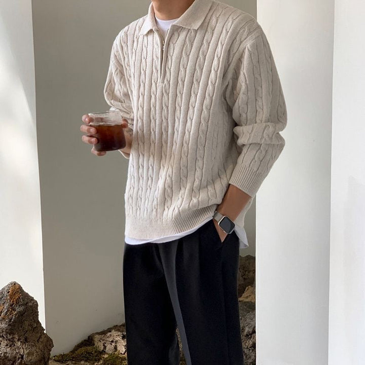 Men's cable knit quarter zip polo jumper in cream – Wrenley – three-quarter view with dark trousers