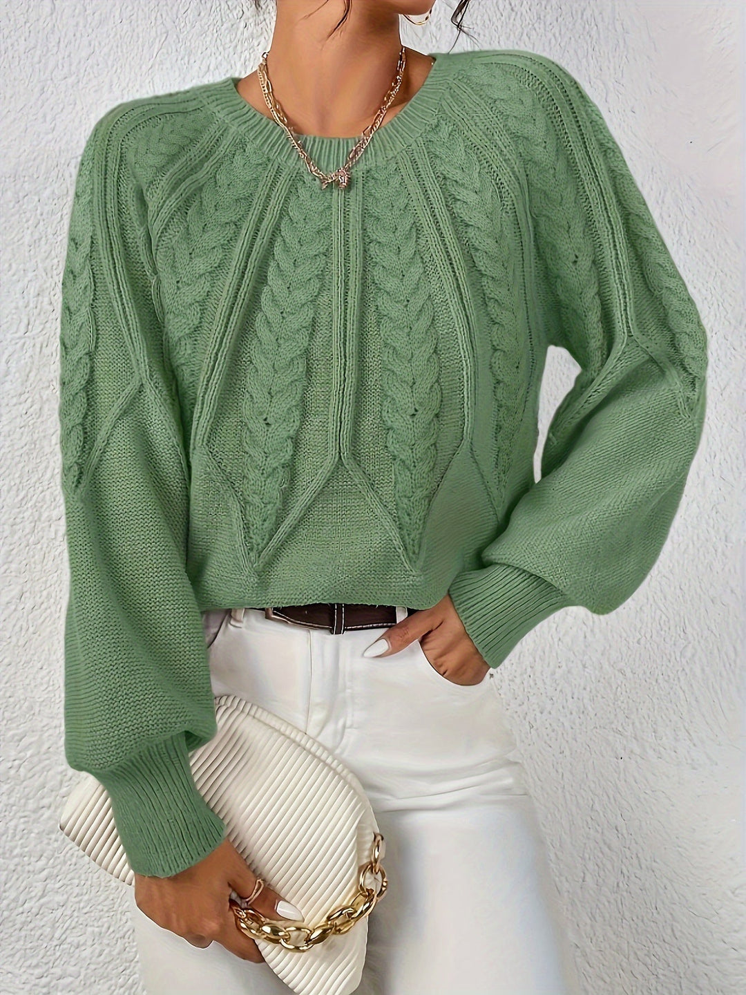Women's cable knit jumper Ulla in Matcha – model view with clutch