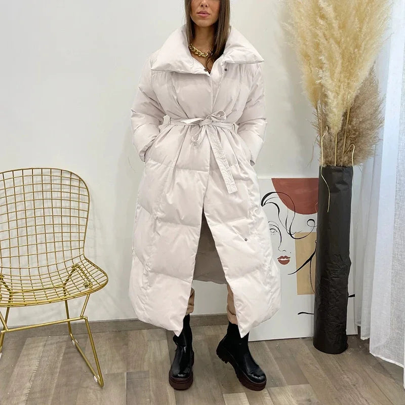 Women's long puffer coat Macey in Beige – worn indoors