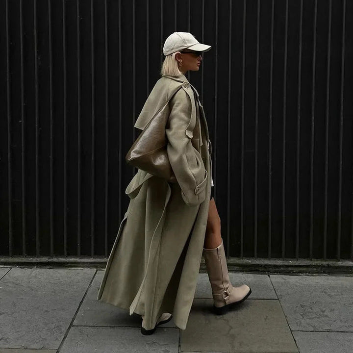 Women's oversized trench coat Sukie in Green – side view walking