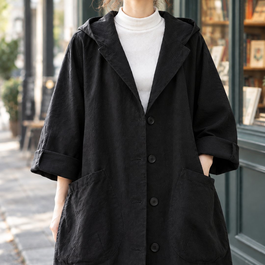 Stockbridge women's longline coat in Black – close-up front view of hood and pockets