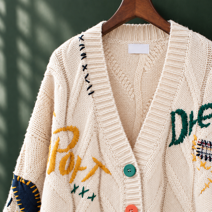 Hermione - Women's embroidered cable knit cardigan in Cream – close-up of embroidery