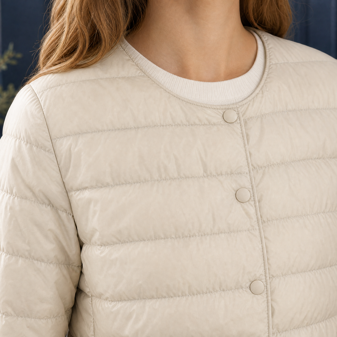 Woodbridge women's quilted down jacket in Cream – collarless neckline and snap front close-up